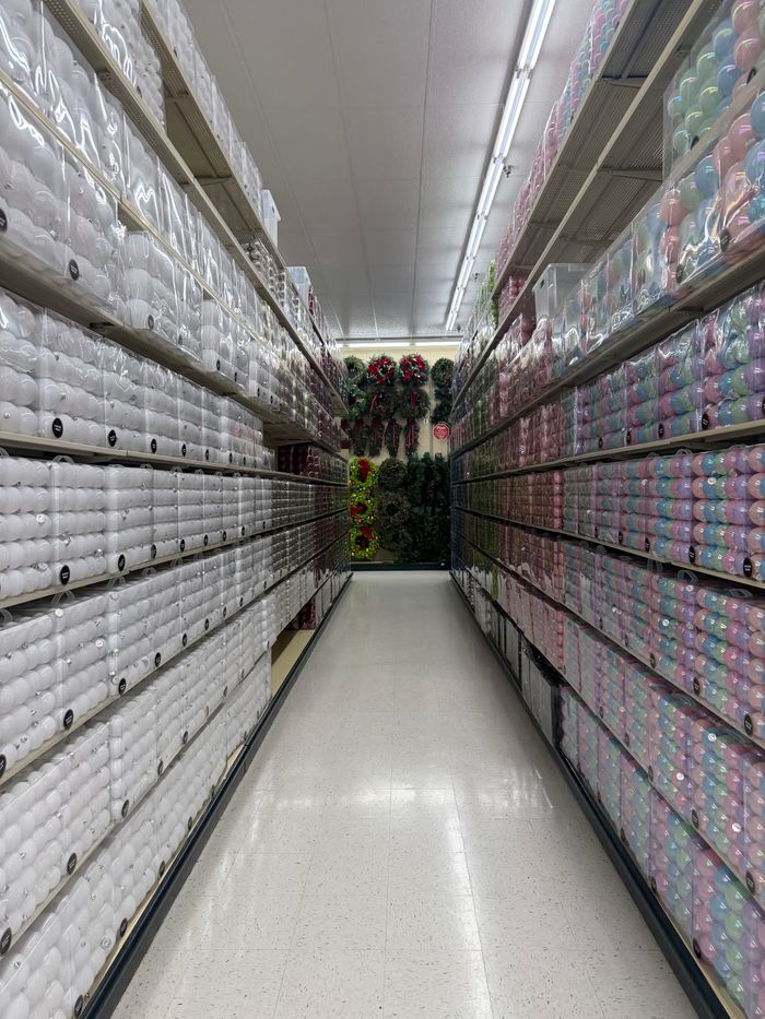 Aisle filled with colorful yarns in a craft store, perfect for knitting and crocheting enthusiasts.