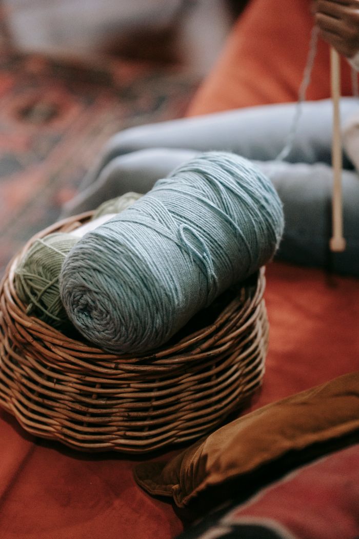 Close-up of yarn balls in a basket, perfect for knitting projects.
